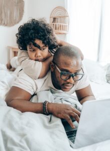 father and child on a laptop